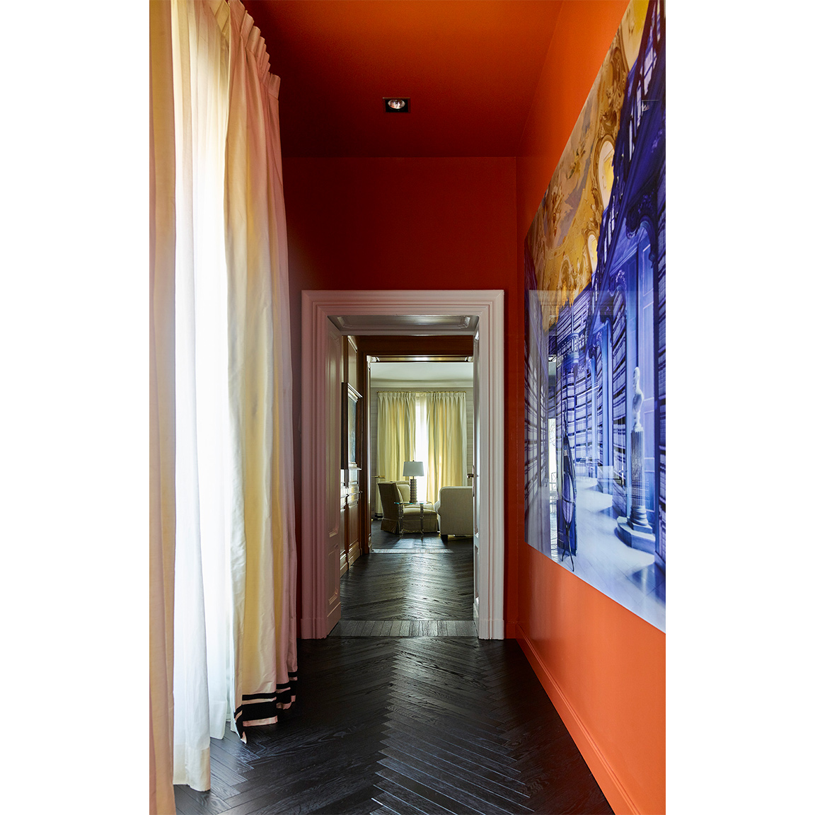orange hallway with big blue and gold picture on wall