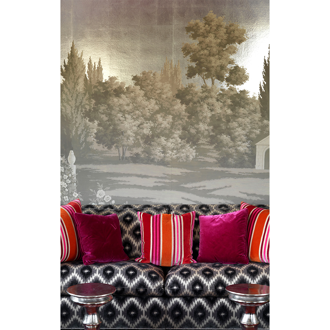 countryside wallpaper behind sofa with pillows