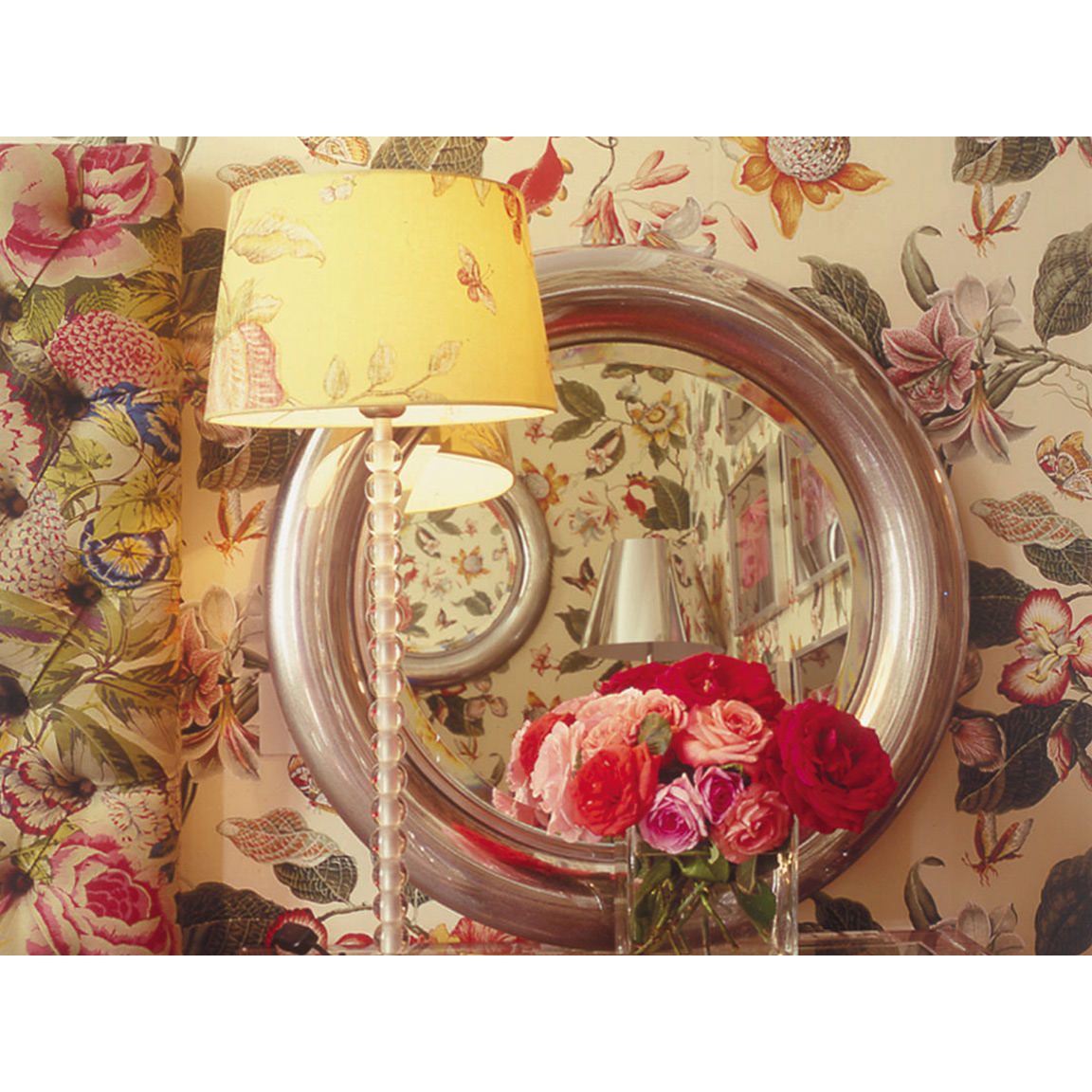 mirror on a floral wall with tablelamp