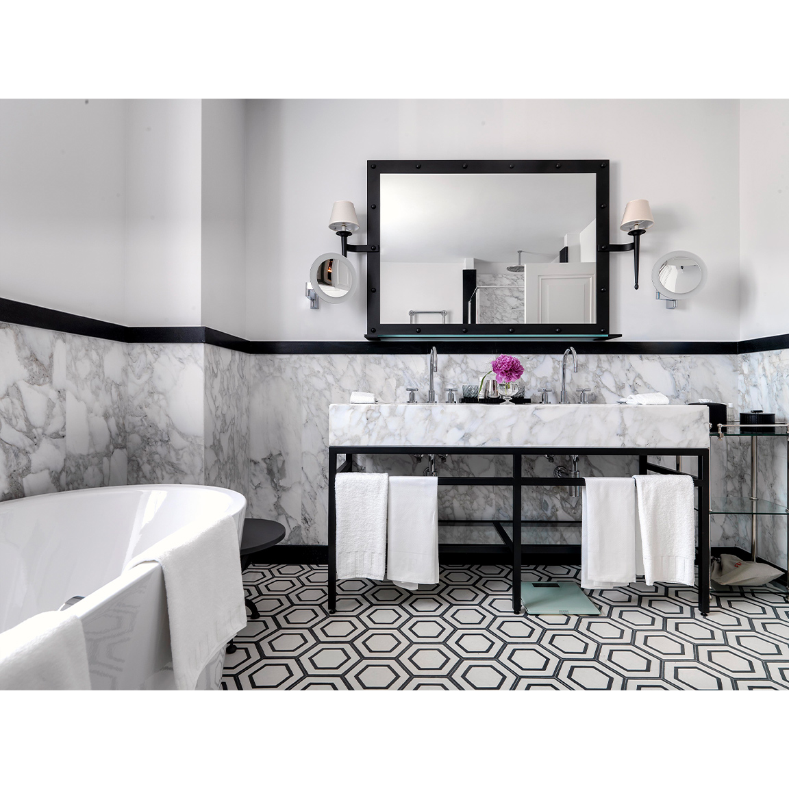 marble bathroom with black and white optical floor tiles
