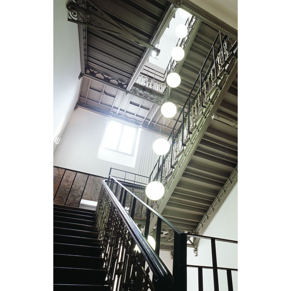 stairs with chandelier