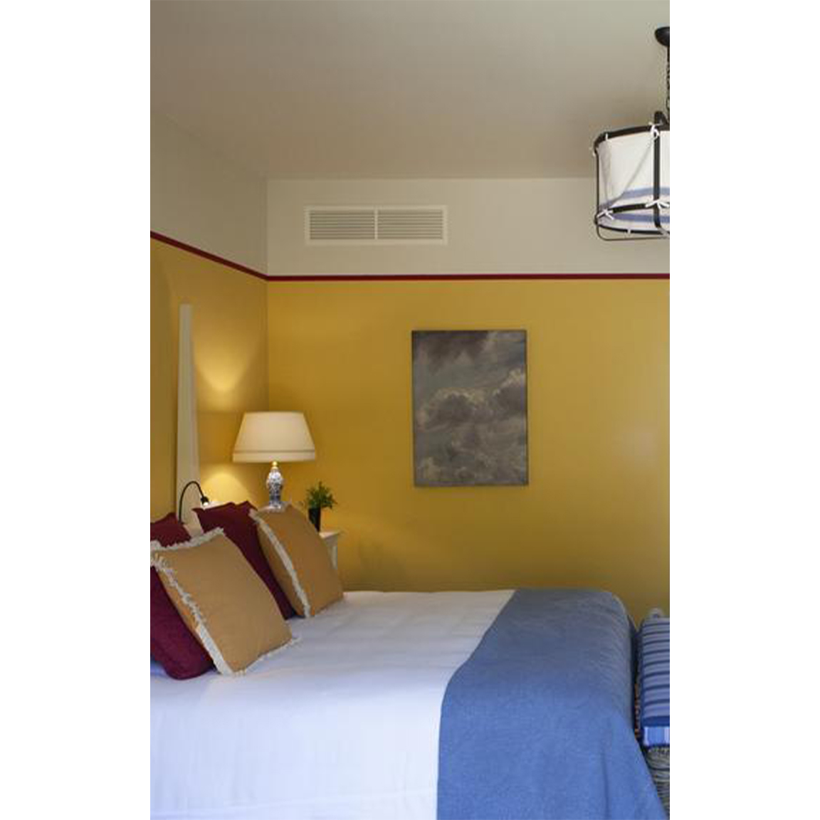 yellow wall with red stripe inside bedroom