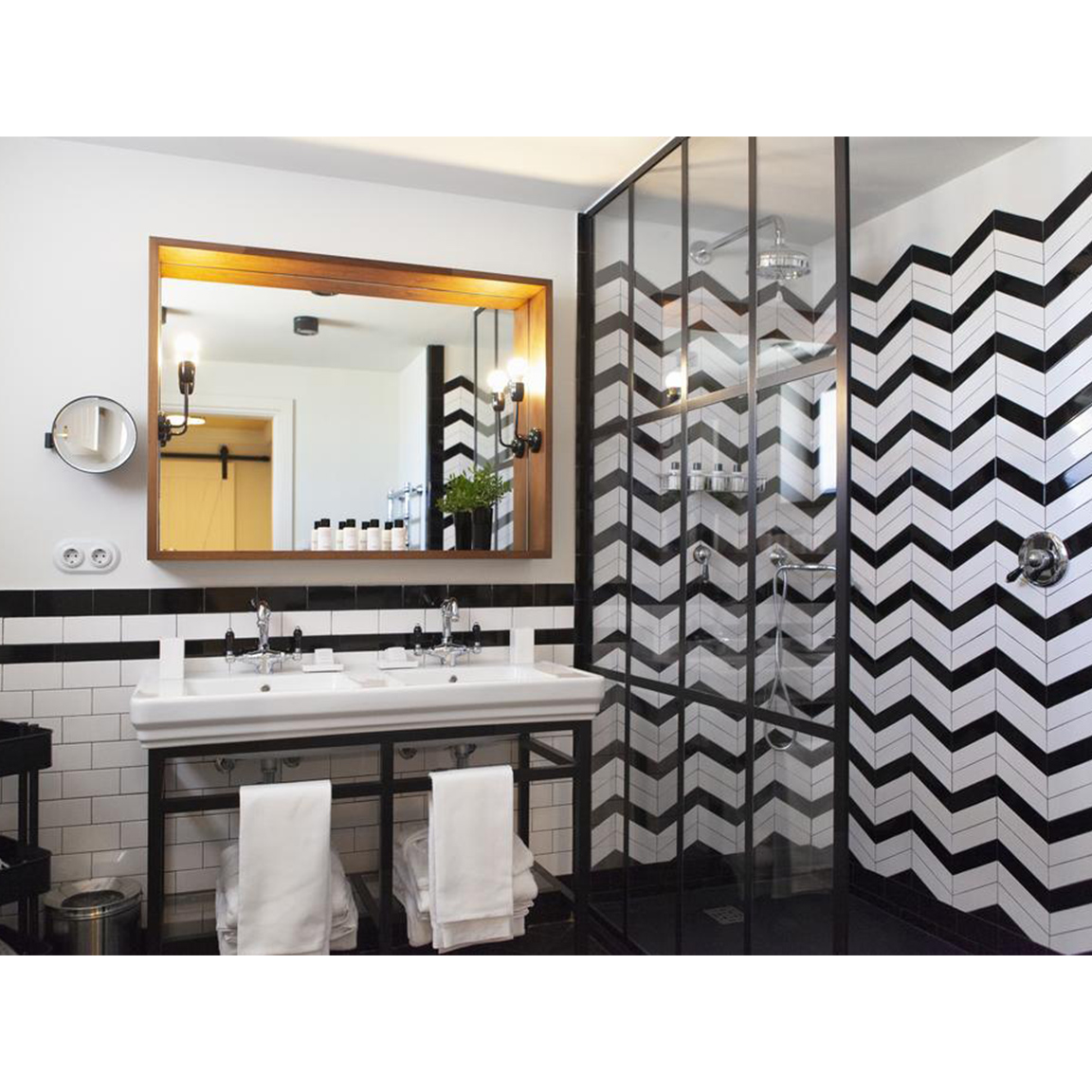 black and white tiles inside bathroom with mirror and sink
