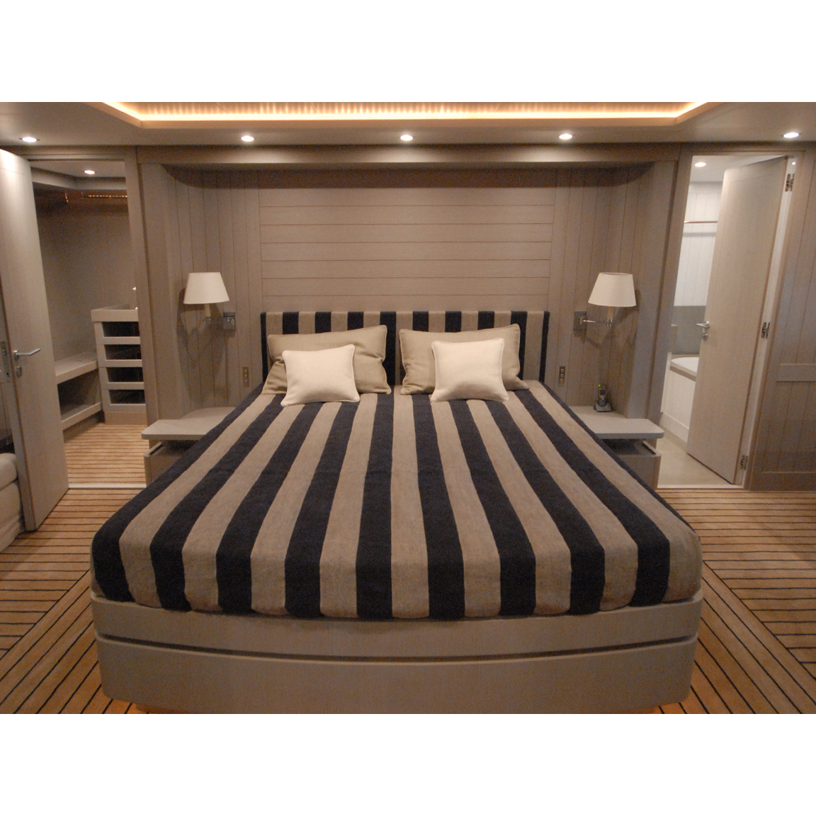 striped double bed and appliques inside a bedroom