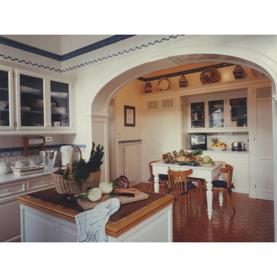 white kitchen with cotto floor