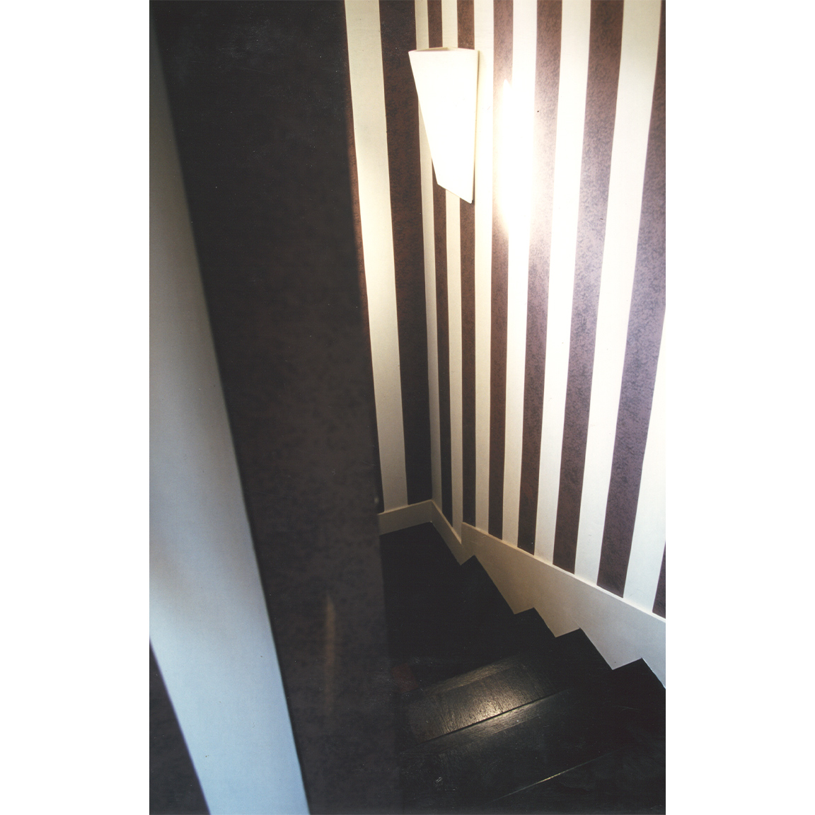 stairs with black and white striped wallpaper