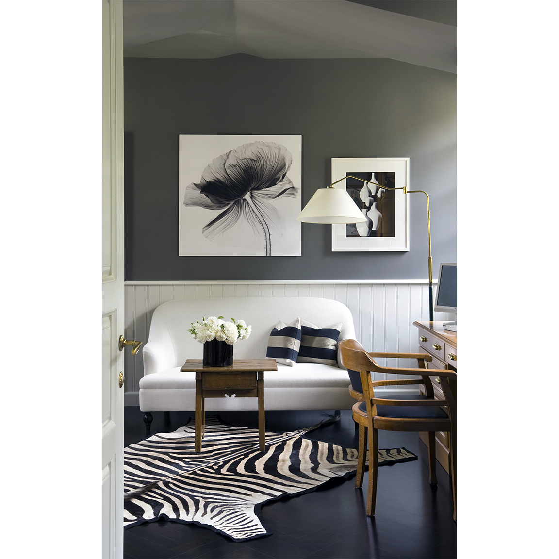 grey walls and black timber floor with zebra skin inside small living room