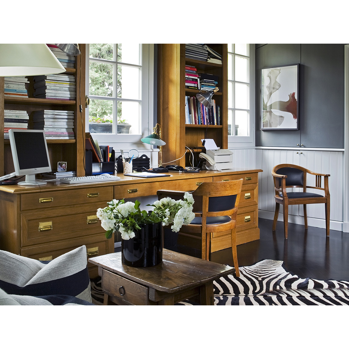 office wooden desk with chairs and zebra carpet