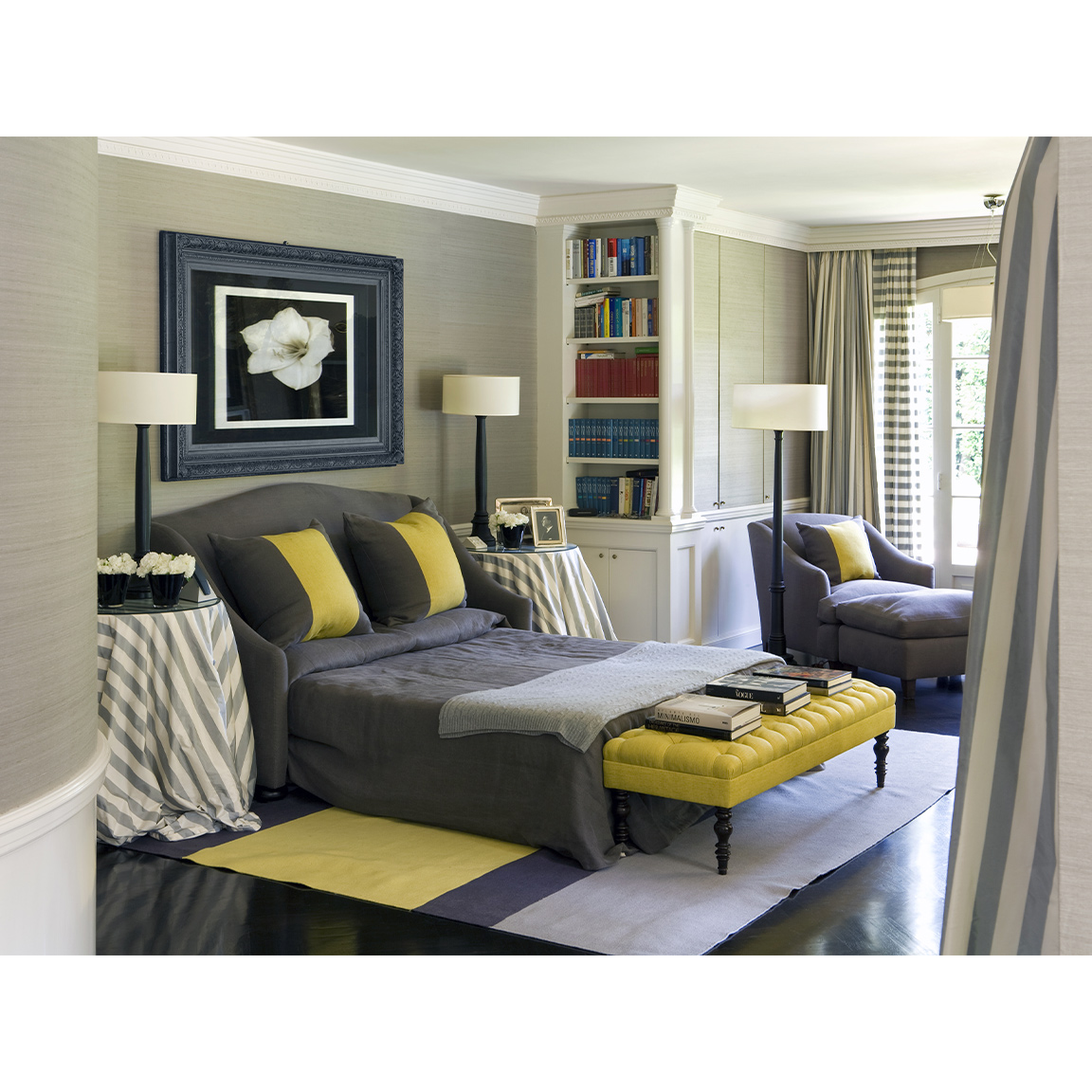 bedroom with grey and yellow bed and armchair
