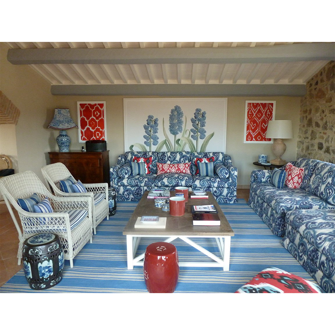 light blue paisley sofas with white wooden armchairs and coffee table inside living room